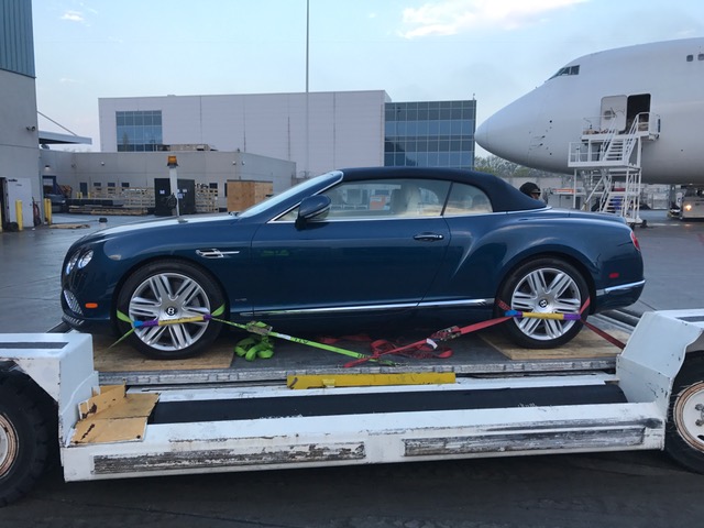 Vehicle being loaded onto cargo plane for export